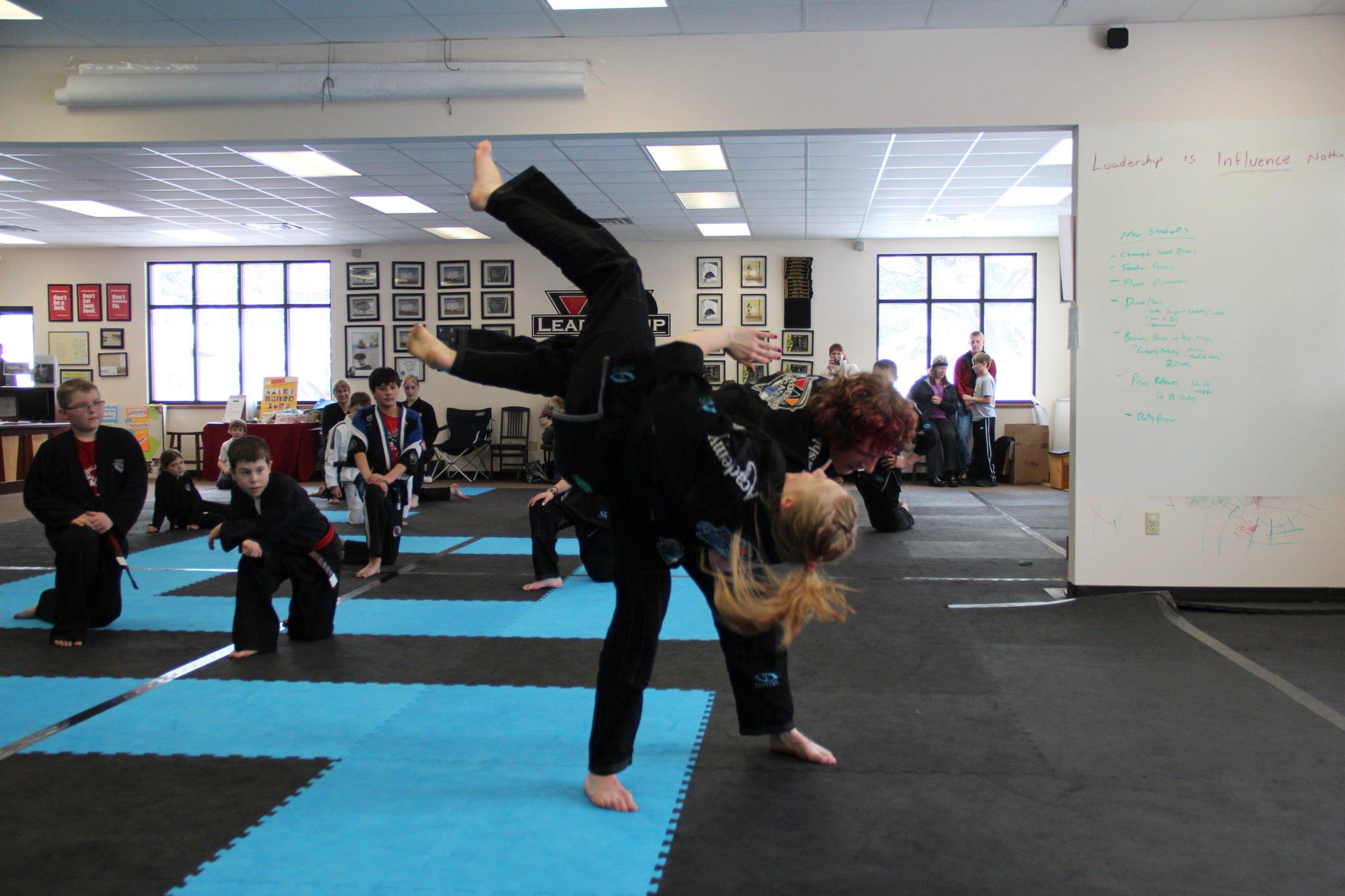 Black Belt testing team meeting on the mat