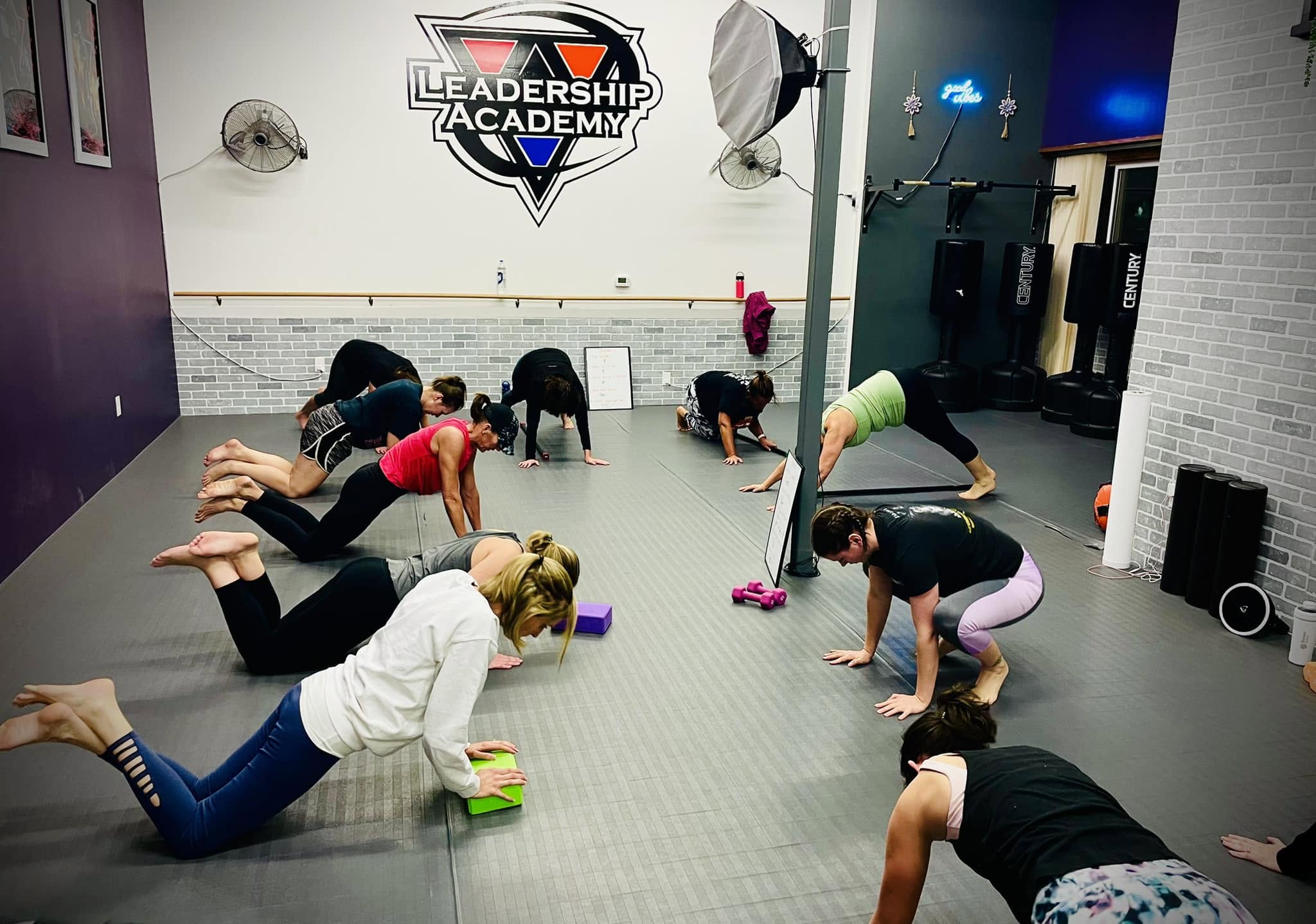 Women doing strength and mobility drills in class