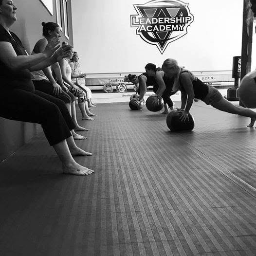 Fitness class cheering during plank work