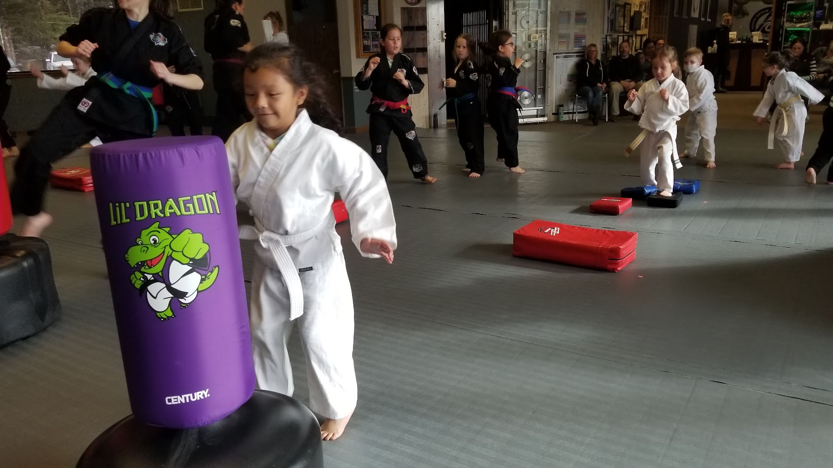 Lil Dragons student moving around a purple training bag